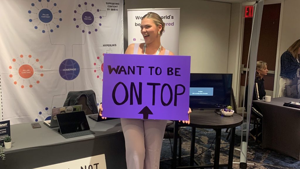 Emilia holding a sign at new york DMWF event