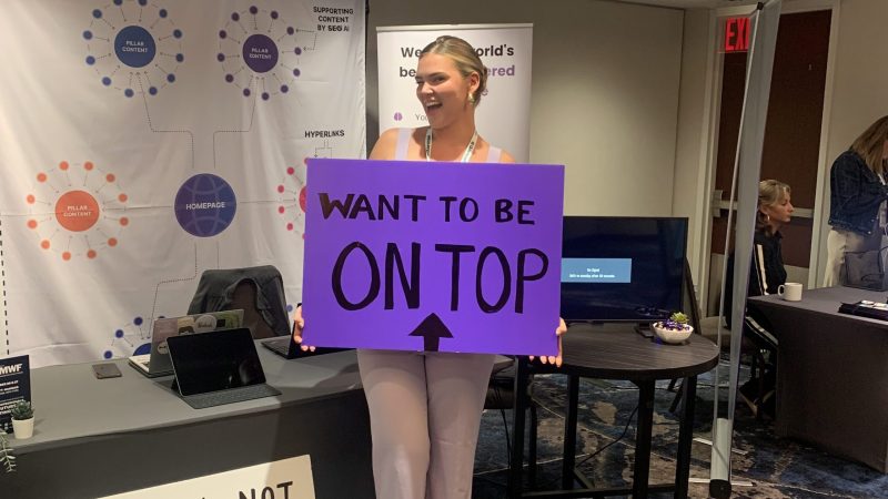 Emilia holding a sign at new york DMWF event