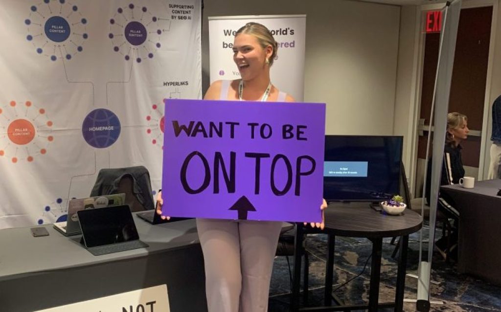 Emilia holding a sign at new york DMWF event